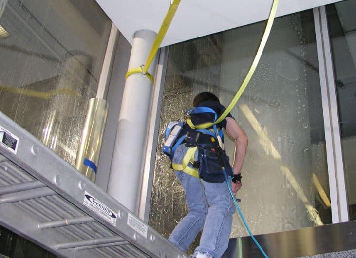 CWS installer with safety harness on government building